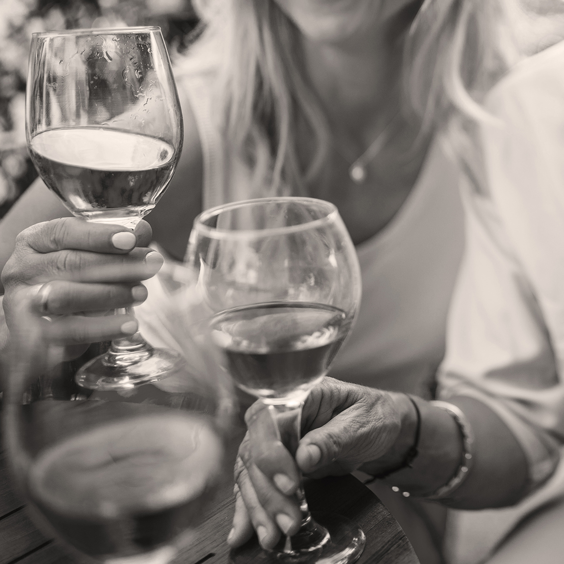 Women holding wine glasses | Creekstone Village