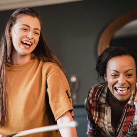 Women playing pool and smiling | Creekstone Village