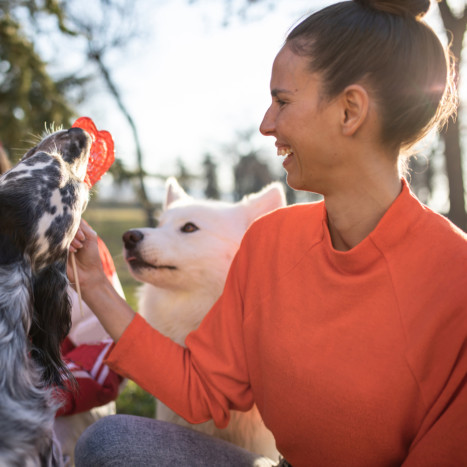 Woman with dogs outside | Creekstone Village